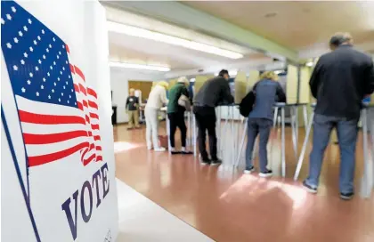  ?? Photos / AP ?? Voter turnout was high across the country, including in Ohio.