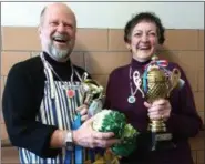  ?? RICHARD PAYERCHIN — THE MORNING JOURNAL ?? Second place winner Bruce Bevan, left, of Amherst, and cabbage roll champion Nancy Lee of Lorain stand together for a photograph with their prizes from the first Stuffed Cabbage Cook Off, a fundraiser held Feb. 25 for the nonprofit Lorain Community...