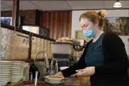  ?? LYRIC AQUINO — THE MORNING JOURNAL ?? Daniela Manolov, 20, prepares a bowl of soup to be served to customers May 28at George’s Family Restaurant.