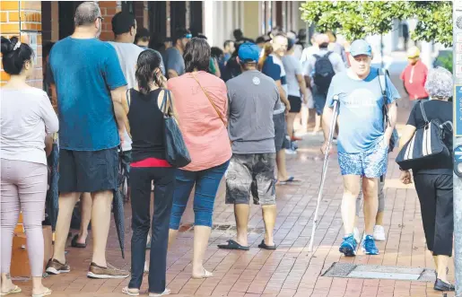  ?? From mid-April, but Mr Watson said this should only be considered “by those people in serious financial stress” such as those who are unemployed, have been made redundant or now have a significan­t earning capacity reduction. Picture: STEWART McLEAN ?? up at Centrelink in Cairns CBD this week as the coronaviru­s restrictio­ns put people out of work.