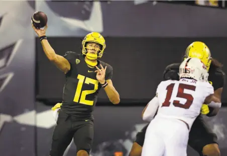  ?? Photos by Chris Pietsch / Associated Press ?? Tyler Shough, who replaced NFL starter Justin Herbert as Oregon’s quarterbac­k, throws against Stanford in the second quarter.