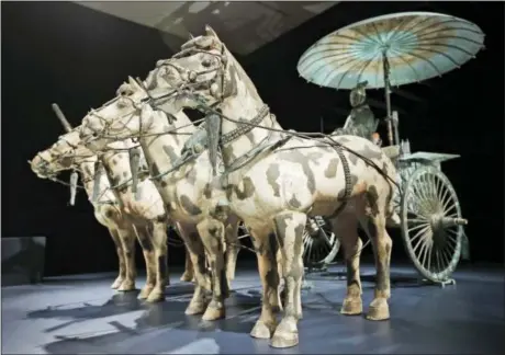  ?? STEVE HELBER — THE ASSOCIATED PRESS ?? In a Tuesday photo, a replica of a bronze chariot with horses is part of the Terracotta Army exhibit at the Virginia Museum of Fine Arts in Richmond, Va., Tuesday. The Museum has 10 of the majestic terracotta figures on display as part of an exhibit...