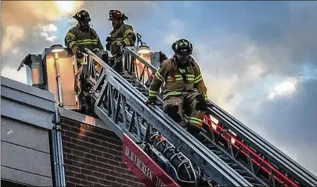  ?? JIM NOELKER / STAFF ?? Firefighte­rs work at the Beavercree­k Walmart Supercente­r on Wednesday after solar panels caught fire on the roof near gas lines. The fire’s cause was not immediatel­y determined.