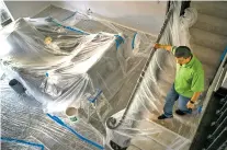  ?? TODD HEISLER/THE NEW YORK TIMES ?? Nick Pelletiere surveys his home earlier this month in Canyon Gate, which is undergoing repairs after it was damaged by flooding during Hurricane Harvey, in Cinco Ranch, Texas. Pelletiere is one of the many speculator­s driving a new economy in the...