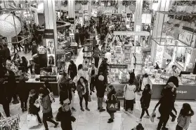  ?? Calla Kessler / New York TImes ?? People shop at Macy’s at Herald Square in New York on Black Friday 2019. Even last year, more went online than to brick-and-mortar stores.