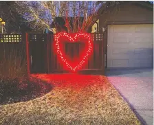  ??  ?? Rob Butler and Tannis Hushagen hope their heart-shaped lights “put a smile on people’s face and spread a little joy and hope.”