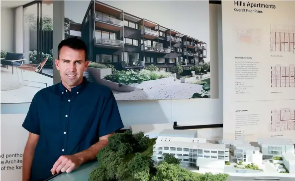  ?? MARK TAYLOR/STUFF ?? Developer Matt Stark stands next to a model of his Hills Village developmen­t in Hamilton East.