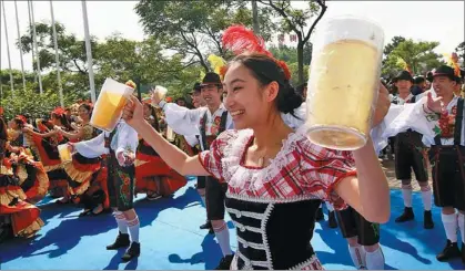  ?? XU CHONGDE / FOR CHINA DAILY ?? Performers celebrate the opening of the Qingdao Beer Festival in August 2013.