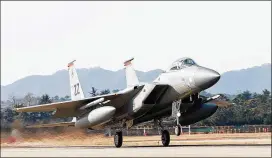  ?? SENIOR AIRMAN COLBY L. HARDIN / U.S. AIR FORCE ?? A U.S. Air Force F-15 lands Saturday at Gwangju Air Base in Gwangju, South Korea. The Asian nation and the U.S. will launch a large-scale military joint exercise, which was scheduled before the North’s latest missile test.