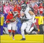  ?? Ed Zurga
The Associated Press ?? Jalen Hurts scores against L’jarius Sneed in leading the Eagles past the Chiefs on Monday, the QB’S 26th win in his past 28 regular-season starts.