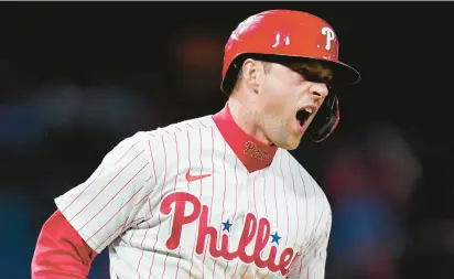  ?? MATT SLOCUM/AP ?? Rhys Hoskins reacts after hitting a two-run home run against the Atlanta Braves on Friday. Saturday’s game ended too late for this edition.