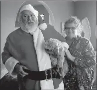  ?? Special to the Democrat-Gazette ?? Dennis and Kelley Whitbey officially met after he tried to steal candy from her birthday basket at work. Each year, Dennis plays Santa for the children at the Arkansas Enterprise for the Developmen­tally Disabled, and Kelley is, of course, his Mrs. Claus.