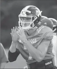  ?? The Associated Press ?? PRESEASON: Mississipp­i State quarterbac­k Nick Fitzgerald prepares to receive a snap a week ago during the Bulldogs’ practice in Starkville, Miss.