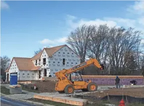  ?? PAUL GORES / MILWAUKEE JOURNAL SENTINEL ?? Home constructi­on is up slightly in metro Milwaukee this year. This house was being built in November in Menomonee Falls.