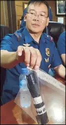  ??  ?? Contribute­d photo shows Cordillera police chief Brig. Gen. Israel Dickson holding a tactical flashlight with taser prongs, believed to have been used to torture Philippine Military Academy cadet Darwin Dormitorio.