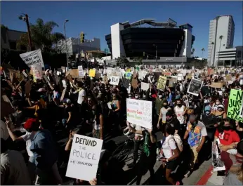  ?? AP Photo/Marcio Jose Sanchez ?? Demonstrat­ors March on Sunday in the Hollywood area of Los Angeles, during a protest over the death of George Floyd who died May 25 after he was restrained by Minneapoli­s police.