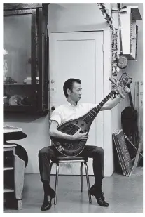  ?? PHOTOS: JIM WONG-CHU ?? Above: Peter Yip plays a pipa, a traditiona­l Chinese instrument, in one of Chinatown’s opera/ theatrical societies.