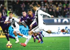  ??  ?? Juventus’s striker Cristiano Ronaldo from Portugal kicks a penalty to score during their Serie A football match against Fiorentina at the Artemio Franchi Stadium in Florence. — AFP photo