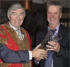  ??  ?? Mayor Tony Dempsey makes a presentati­on to Eddie Cassidy, Wexford Toastmaste­rs president, to mark the tenth anniversar­y.