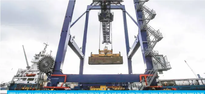  ??  ?? LONDON: A container ship is unloaded at the Port of Immingham operated by Associated British Ports (ABP) on the south bank of the Humber Estuary, eastern England. Maritime freight volumes have dropped in the last year due to protection­ism and the weakening of internatio­nal commerce. — AFP