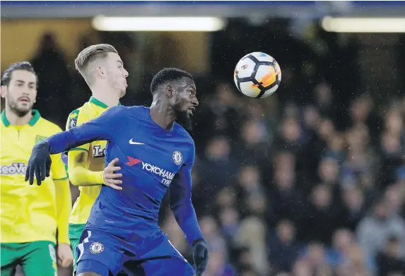  ?? — THE ASSOCIATED PRESS ?? Norwich City’s James Maddison, left, and Chelsea’s Tiemoue Bakayoko duel for the ball with during FA Cup action on Wednesday. The lower-tier Canaries pushed Chelsea to the limit before falling short on penalties.