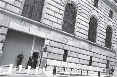  ??  ?? Security guards stand outside of the Federal Reserve Bank of New York in the Manhattan borough of New York City. REUTERS