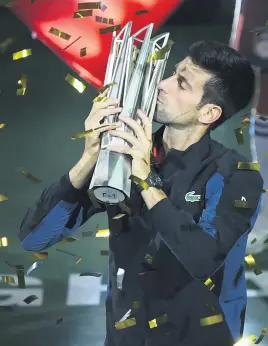  ?? Picture: AFP ?? DOMINANT. Serbia’s Novak Djokovic kisses the trophy after winning the Shanghai Masters beating Croatia’s Borna Coric in the final yesterday.