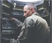  ?? AP PHOTO/ANDRIY ANDRIYENKO ?? A Ukrainian serviceman with the 65th Brigade sits inside an armored vehicle April 21 as he defends the front line in the Zaporizhzh­ia region of Ukraine.