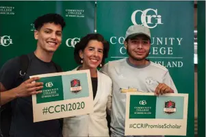  ?? Photos by Kendra Port ?? Gov. Gina Raimondo smiles for a photo on Thursday with Pawtucket residents Pablo Santos (left) and William Mejia (right), at “Rhode Island Promise Day” at CCRI.