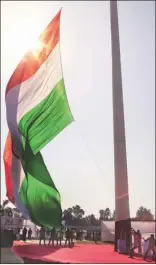  ??  ?? Workers hoist the national flag (right) on a 207-ft pole after President Pratibha Patil, flanked by (from left) Haryana Governor Jagannath Pahadia, CM Bhupinder Singh Hooda and MP Naveen Jindal, presses the button to start the process, at Brahmasaro­var...