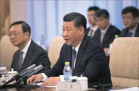  ?? Nicolas Asfouri/AFP/Getty Images ?? China’s President Xi Jinping speaks with Japan’s Prime Minister Shinzo Abe (not in picture) during a meeting Friday at the Diaoyutai State Guesthouse in Beijing.