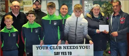  ??  ?? Mentors Tomas McVeigh, Johnny Hyland and Stephen Leacy, along with members of the Rapparees-Starlights U13 team, present a cheque for €535 to Fr Odhran Furlong and Patricia Byrne of the Enniscorth­y Group of the Irish Pilgrimage Trust.