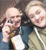  ?? ?? Cyril Walsh of St Patrick’s Mills presenting ‘Lucinda Batch bottle No. 1’ to Lucinda McDonald in recognitio­n of her investigat­ive work on the spirit.
