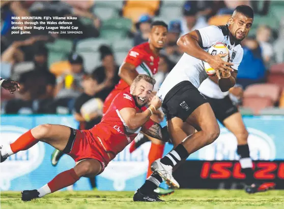  ?? Picture: ZAK SIMMONDS ?? MAN MOUNTAIN: Fiji's Viliame Kikau breaks through the Wales defence during their Rugby League World Cup pool game.