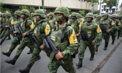  ??  ?? Soldiers march through Tuxtla Gutiérrez, capital of the southern border state of Chiapas, in a show of force aimed at deterring Central American migrants. Photograph: Jacob Garcia/Reuters