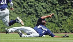  ?? JON DURR, GETTY IMAGES ?? Lorenzo Cain is unable to make a catch on a fly ball hit by David Bote during the fourth inning.