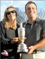  ?? AP/JON SUPER ?? Francesco Molinari holds the claret jug with his wife Valentina after winning the British Open on Sunday. Molinari finished at the top of a leaderboar­d that included past major champions Rory McIlroy, Justin Rose, Tiger Woods and Jordan Spieth.