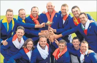  ??  ?? Thomas Bjorn celebrates with his jubilant Europe side last Sunday