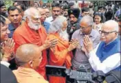  ??  ?? Senior BJP leader LK Advani greets priests Dharam Das and Ram Vilas Vedanti, coaccused in the Babri demolition case, as UP CM Yogi Adityanath looks on, in Lucknow on Tuesday. DEEPAK GUPTA / HT