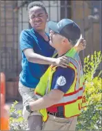  ??  ?? A firefighte­r carries one of the children injured in Tuesday’s crash at a constructi­on site on West Washington Avenue.