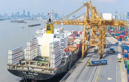  ??  ?? Cranes load cargo onto a vessel at Bangkok port. Exports rose by a healthy 12.5% in the third quarter, spurring GDP growth to a multiyear high.