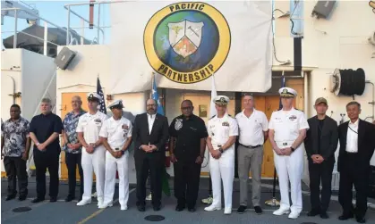  ?? Photograph: Charley Piringi/AFP/Getty Images ?? Military and civil representa­tives from Australia, the US, Japan and Solomon Islands attend a ceremony marking the Pacific Partnershi­p on board USNS Mercy in Honiara. Solomon Islands has rejected a US draft agreement for the Pacific.