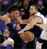  ?? The Associated Press ?? BITTER RIVALS: Golden State Warriors guard Stephen Curry, right, defends Oklahoma City Thunder guard Russell Westbrook during the second half of an NBA basketball game Wednesday night in Oakland, Calif. Curry was announced as an All-Star starter on...