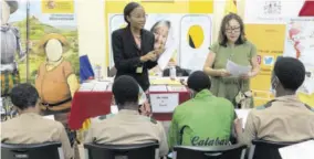  ?? (Photo: JIS) ?? Assistant for economic and cultural Affairs at the Embassy of Spain, Suzette Wood (left) leads a session with Caribbean Secondary Education Certificat­e students during a Spanish orals workshop held as part of Spanish Immersion Day activities at Kingston and St Andrew Parish Library in March 2023. At right is administra­tive officer, Embassy of Spain, Julia Mendoza