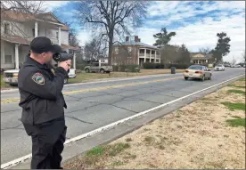  ?? / Adam Cook ?? Ringgold Police Capt. Chris Faulk demonstrat­es one of the new LIDAR guns. The equipment was recently purchased with grant funds awarded by the Governor’s Office of Highway Safety.