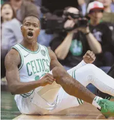  ?? STAFF PHOTO BY MATT WEST ?? NO TIME TO SIT STILL: Terry Rozier celebrates after hitting a 3-pointer and drawing a foul during the Celtics’ victory Sunday night against the Raptors.