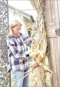  ?? LYNN KUTTER ENTERPRISE-LEADER ?? Amy Daniels with The Junk Ranch decorates the entrance for the two-day vintage fair that will be held Friday and Saturday in Prairie Grove. Thousands of people are expected to come through Prairie Grove and Lincoln this weekend for the Arkansas Apple...