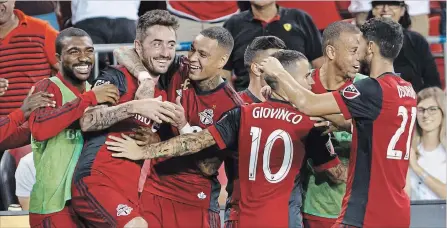  ?? COLE BURSTON THE CANADIAN PRESS ?? Midfielder Jay Chapman, second from left, celebrates his goal with teammates during the second half of Major League Soccer action against the Los Angeles Galaxy at BMO Field in Toronto on Saturday. Toronto FC won the game 5-3, keeping their playoff hopes alive.
