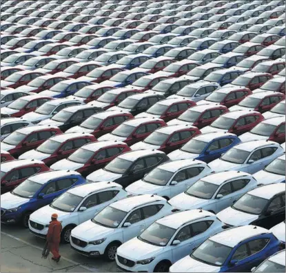  ?? WANG CHUN / FOR CHINA DAILY ?? Chinese-made export-bound vehicles wait to be shipped at the Lianyungan­g Port in Jiangsu province on Dec 7. China’s foreign trade expanded 7.8 percent year-on-year in November, with exports jumping 14.9 percent and imports declining 0.8 percent on a yearly basis.