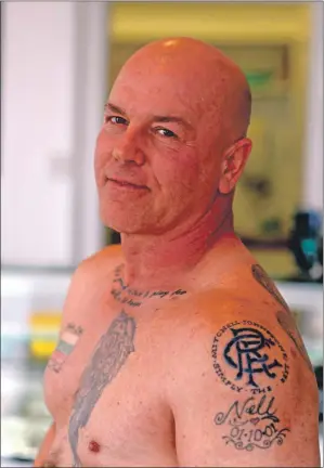  ?? 25_c43tattoo0­1 ?? Angy MacFarlane sporting his Rangers tattoo to benefit Mitchell Johnstone.